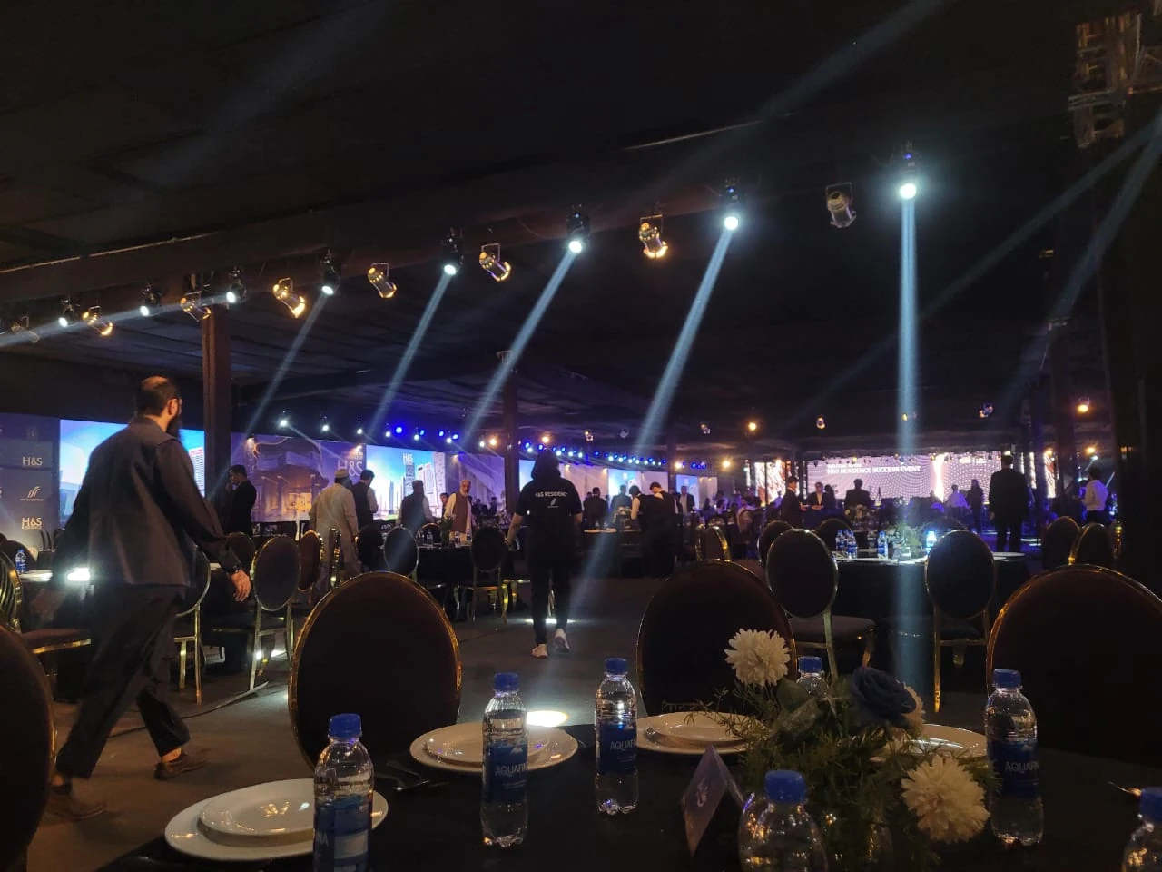An evening gathering with guests and stage lighting.